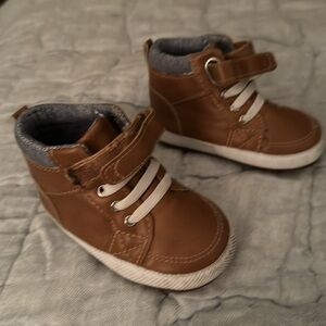 Two different styles of infant shoes. Baby shoes ! Very cute